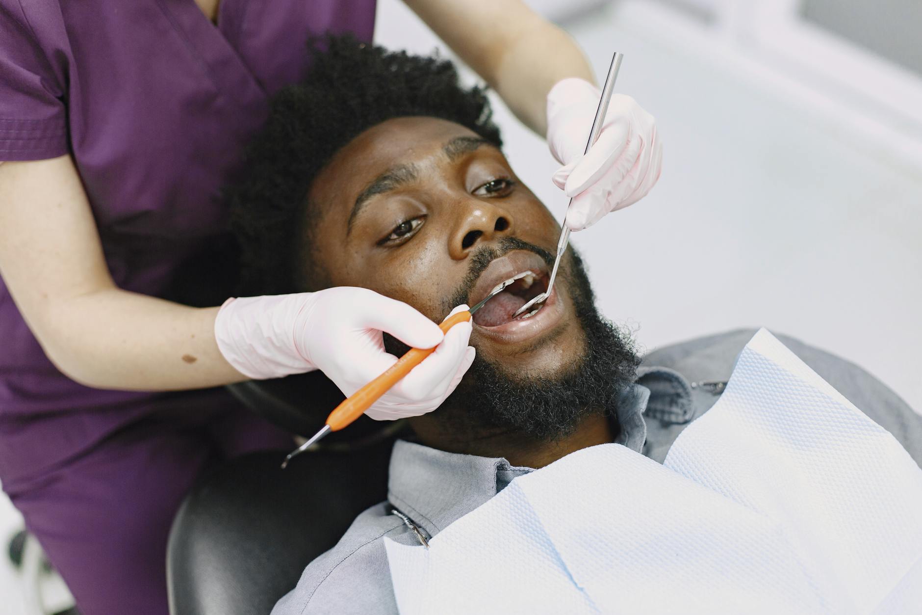 Dentist examining a patient’s teeth during a routine dental checkup